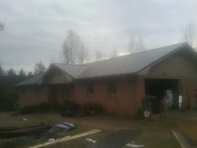 Gray metal roof on a stucco house with an attached garage in Pocatello